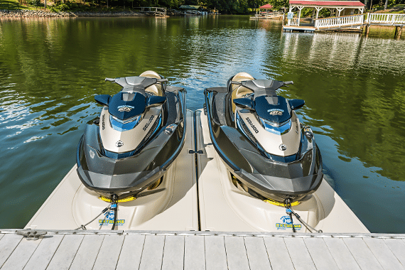 Two WaveRunners on HydroHoist HP Extreme dual PWC ports at a lake dock