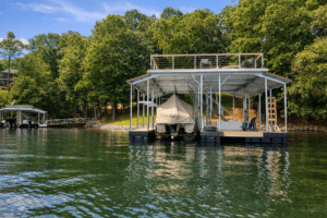 A floating boat dock with a covered boat and a rooftop deck for entertaining