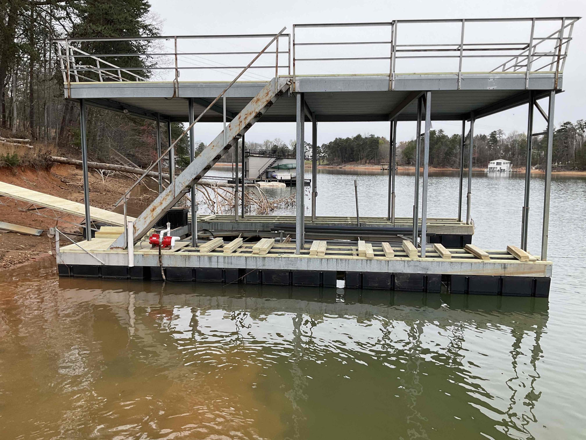 Staircase anchored to the dock frame with new decking