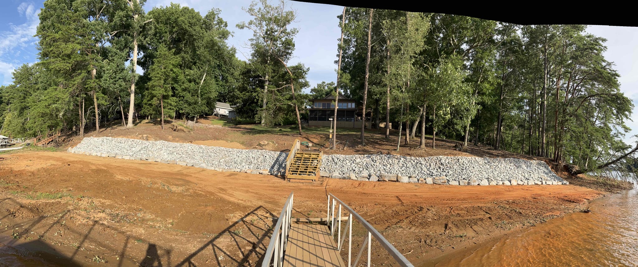 Finished hand-stacked granite rip rap erosion control on residential Lake Lanier shoreline